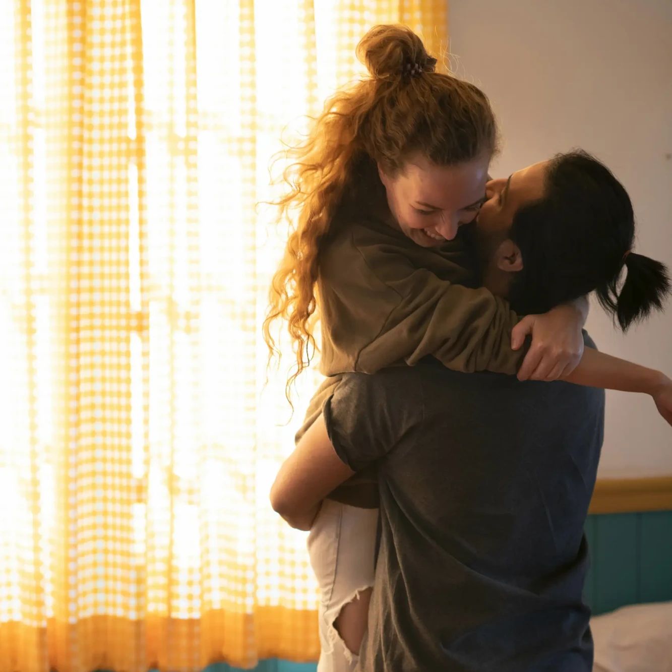 embracing-happy-couple-bedroom-celebrating-new-home